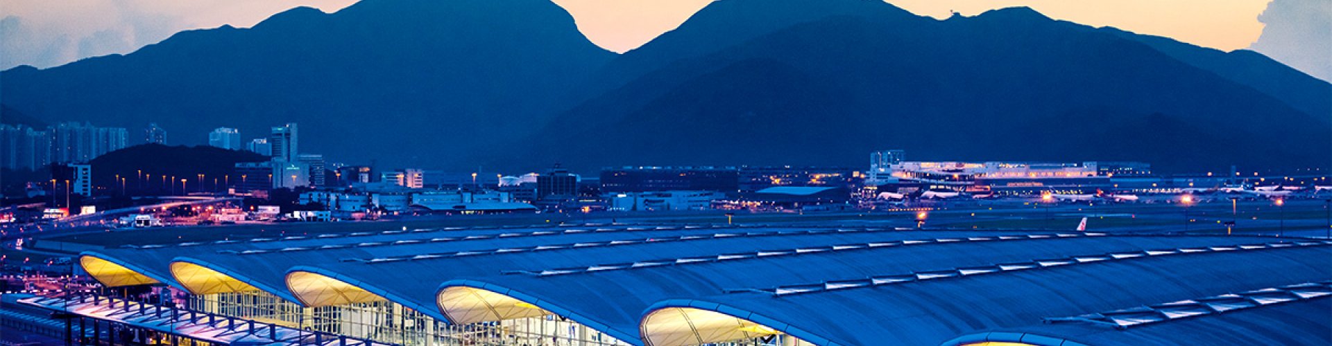 Night view of Hong Kong Intl Airport, HK with city skyline
